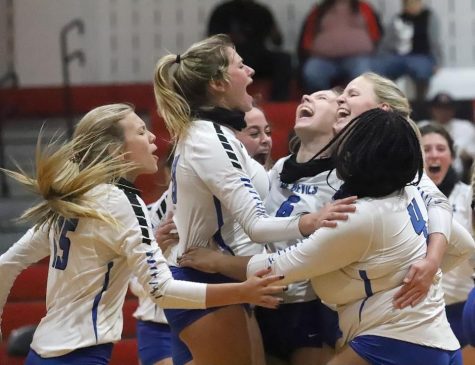 The Lady Devils celebrate after winning against Diboll in five close sets.