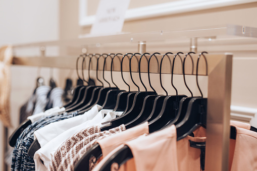 Dresses hanged on a rack in a clothing store