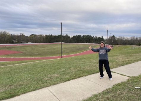 Shelly Binford posing in front of the newly renovated track