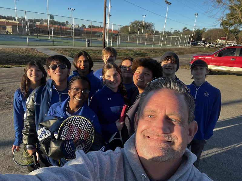 Coach McClain poses with JV Tennis at the Hudson tournament.