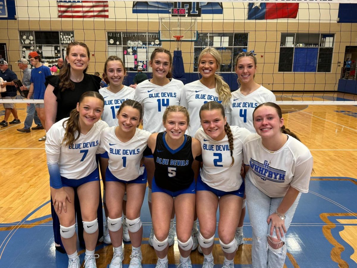 Coach Smoak and seniors smile after senior night win.