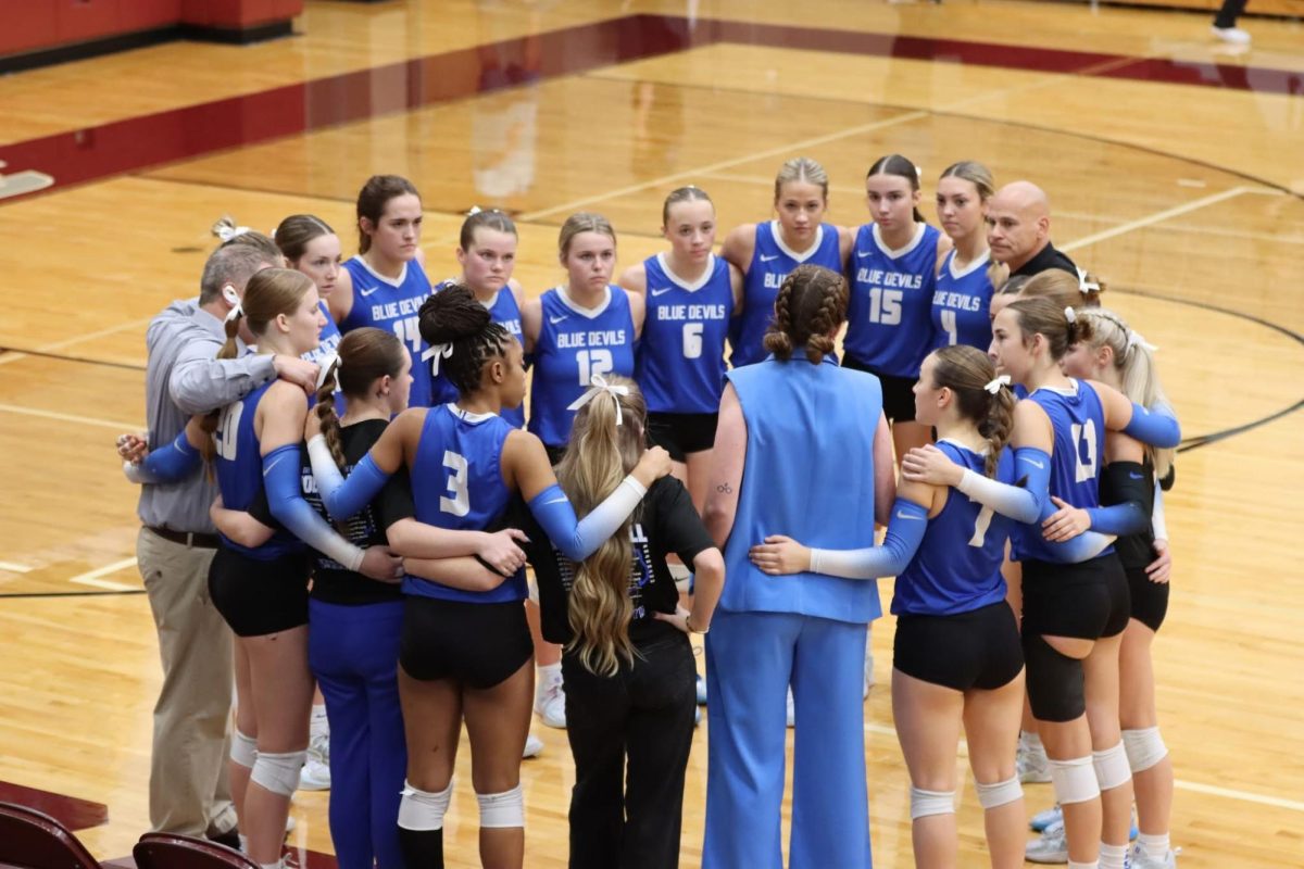 Blue Devil volleyball receives pre-game pep talk from Coach Smoak.