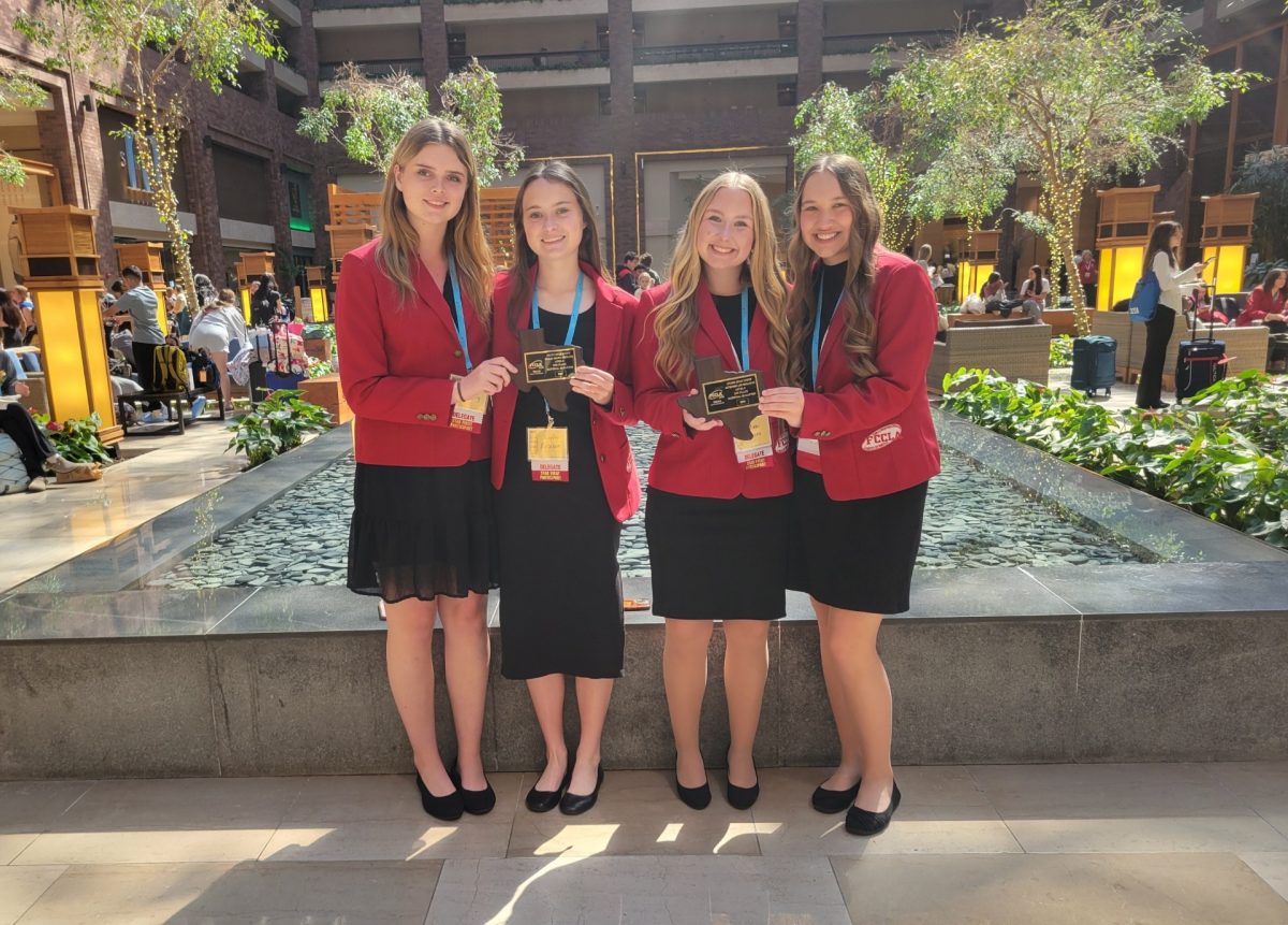 Sophomores Nicole Jacks, Isabella Downing, Lyla Robison and Kate Sparks hold their first and second place plaques from the FCCLA state competition.
