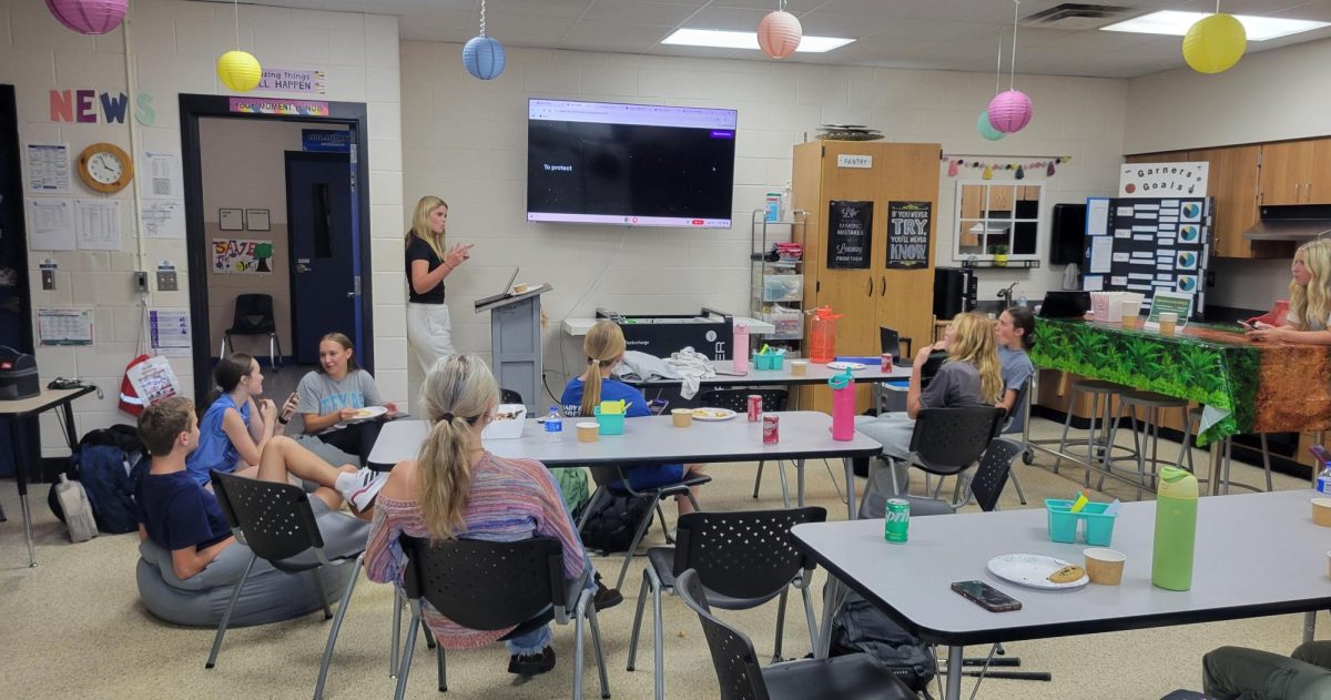 Junior FCCLA officer Bella Downing discusses FCCLA activities at a back-to-school party.