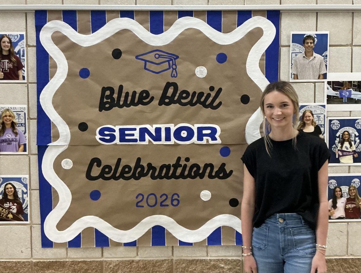Freshman Layton Vardeman volunteers her time to make banners for the school.

